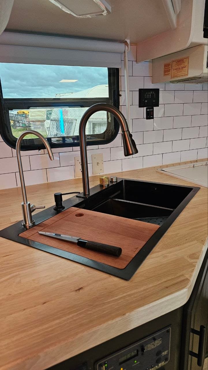 Custom butcher block countertop with black sink and modern faucet