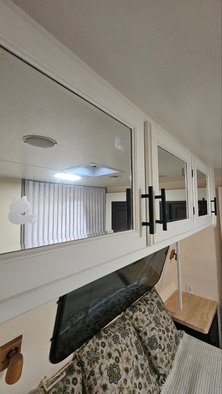 Refinished travel trailer cabinet doors with new black hardware