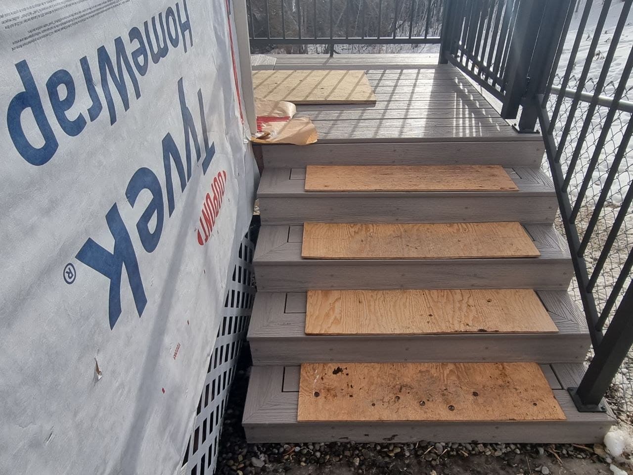 New composite deck stairs with an aluminum railing — Calgary deck and steps rebuild