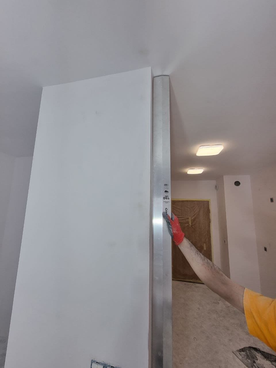 Painter cutting in a wall by hand during an interior repaint
