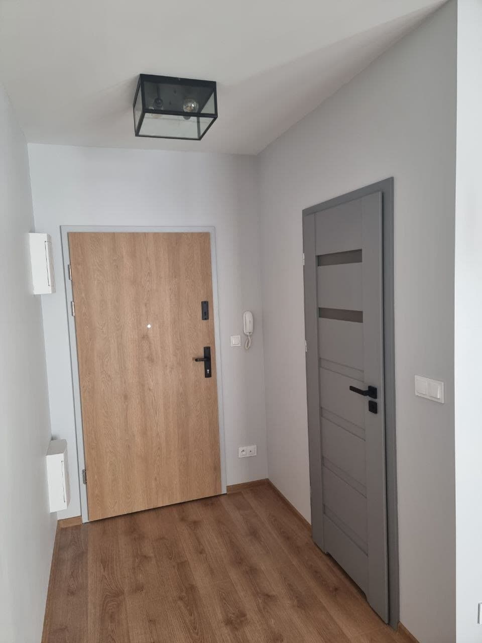 Painted hallway with crisp trim around the doors and new flooring