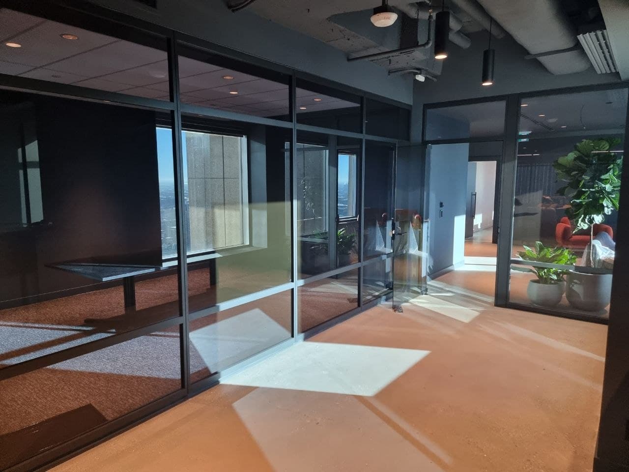 Private glass-walled offices with downtown views and polished concrete floors — Calgary